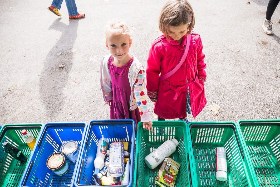 Two girls desposing of hazardous waste (baterries, medicine etc.).